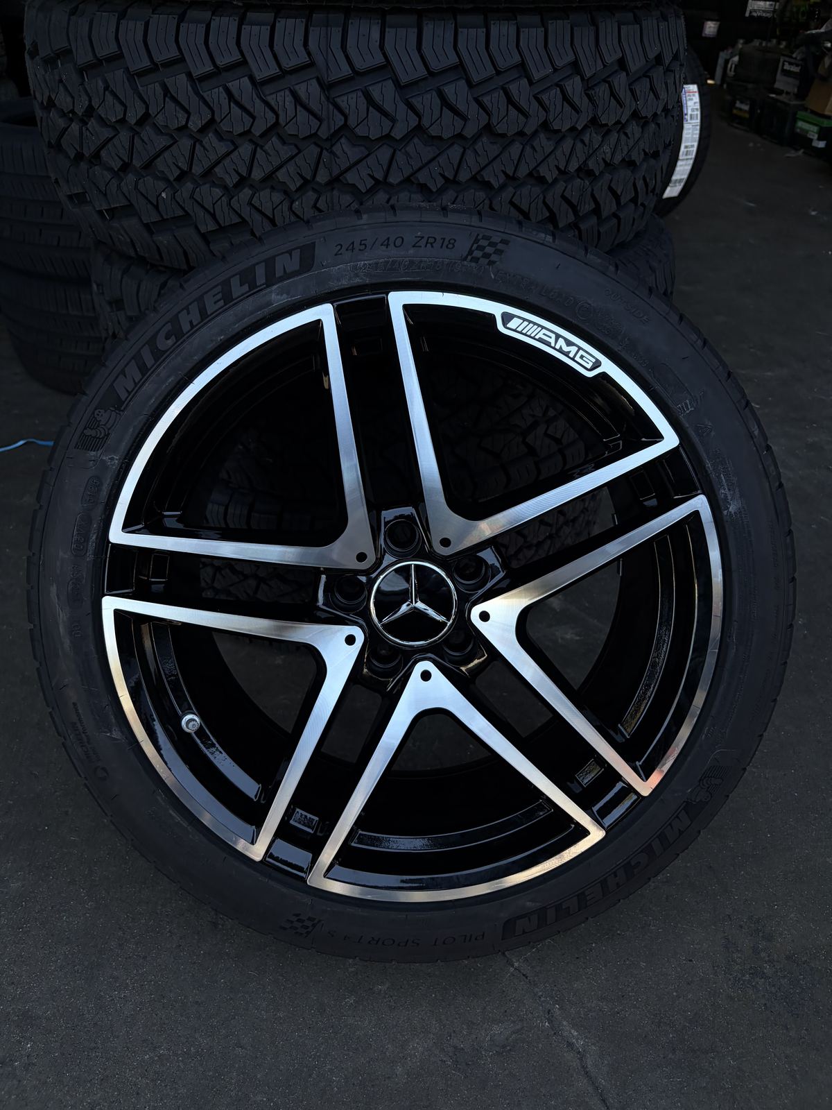 Close-up of a black and machined five-spoke AMG wheel with Michelin tire