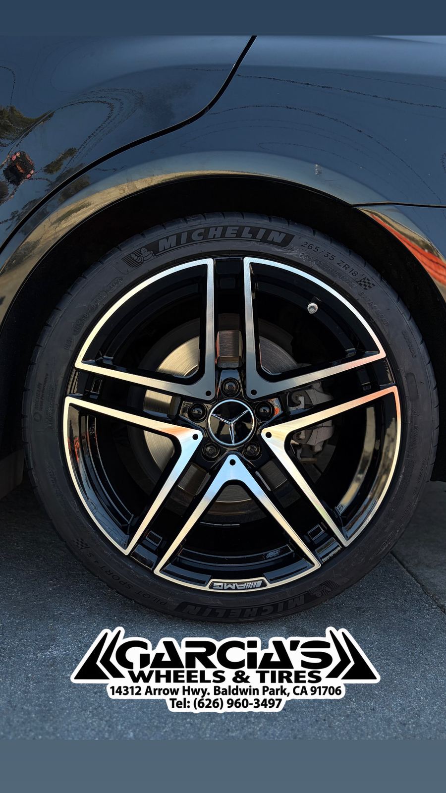 Mercedes sedan fitted with black and machined AMG-style wheels and Michelin tires