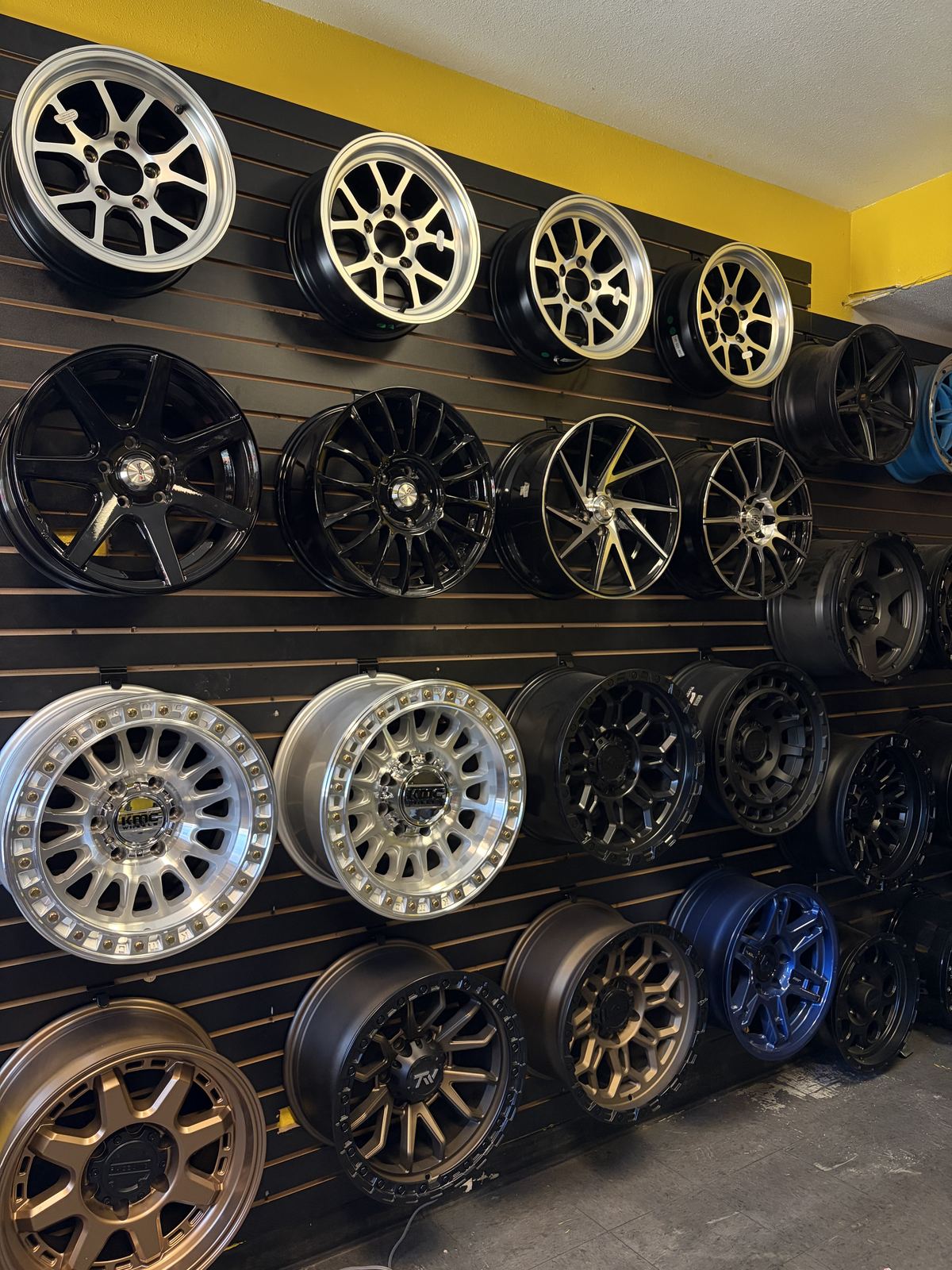 Wall of aftermarket wheels on display inside the shop